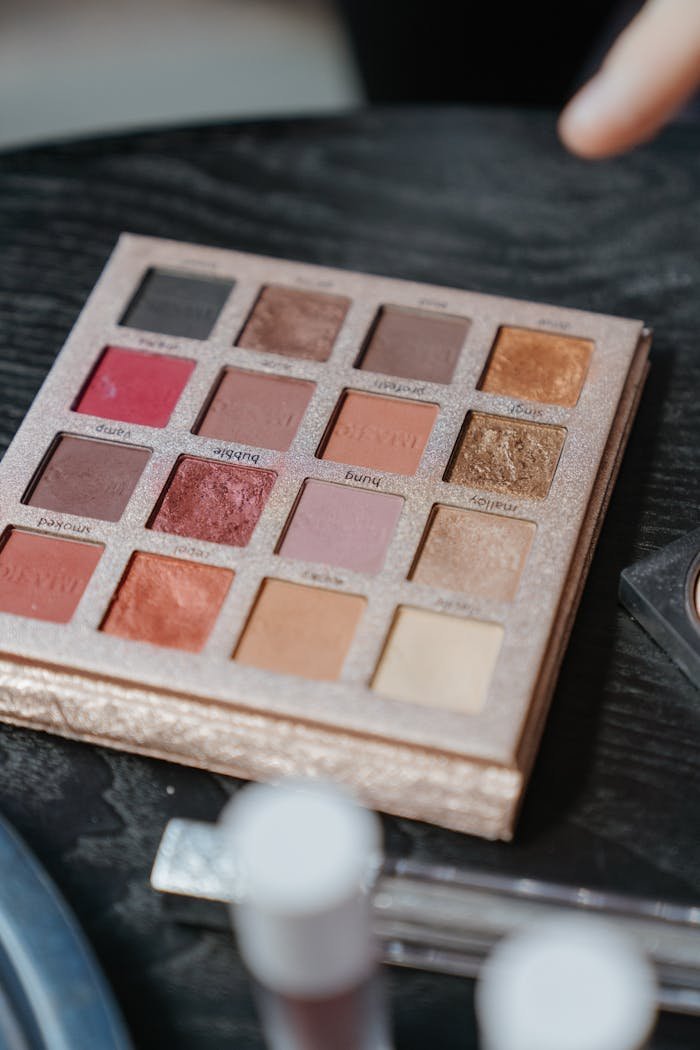 why-choose-us A vibrant eyeshadow palette with diverse colors on a black wooden surface, perfect for makeup enthusiasts.